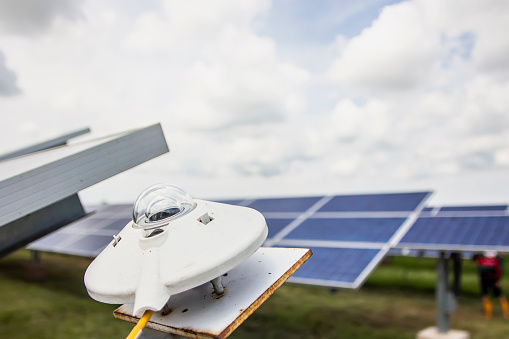 pyranometer for measuring irradiance in solar farm with blue sky.