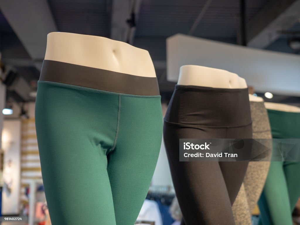 Plastic athletic mannequin lower bodies posing with yoga pants Plastic athletic mannequin lower bodies posing with yoga pants in a store Spandex Stock Photo