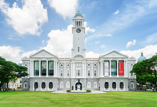 Singapore - February 17, 2017: Main view of the Victoria Theatre and Concert Hall. Beautiful clock tower on blue sky background. Singapore is a popular tourist destination of Asia.