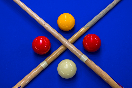 Billiard balls, cue in a blue pool table