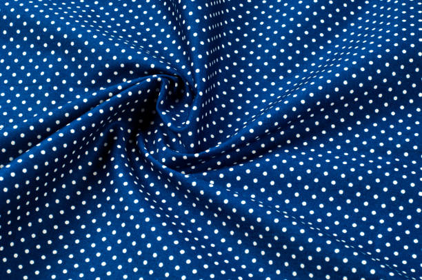 istock Texture background pattern. Abstract background of a luxurious blue fabric in white polka dots wavy folds of a grunge silk texture of a satin velvet material or a luxurious background or elegant wallpaper 981418868