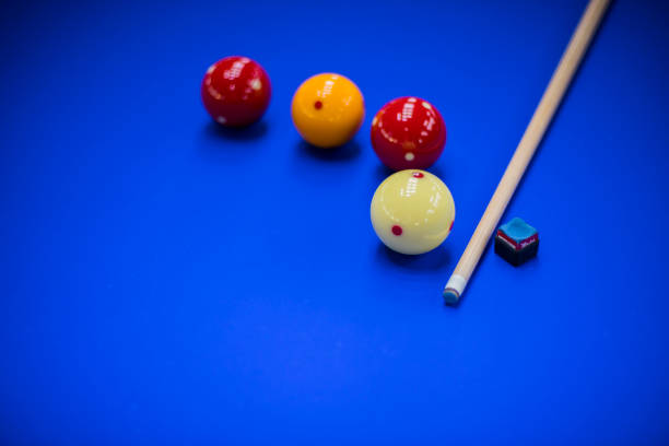 istock Billiard balls, cue and chalk in a blue pool table 981419032