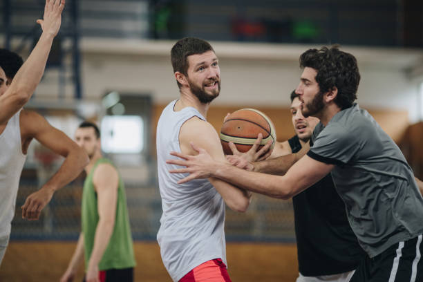 istock Determined basketball player making an effort while trying to pass his rivals. 981419364