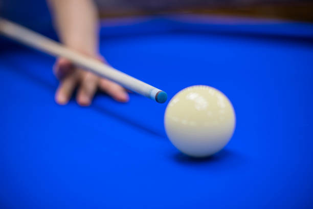 istock Hand with cue before the a blow to billiard ball 981420116