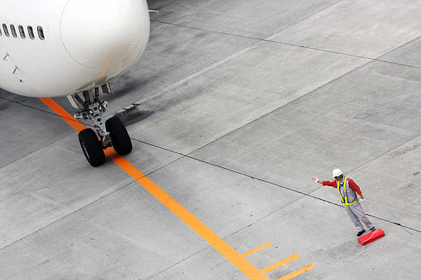 istock An airfield worker signaling a plane forward 98142609