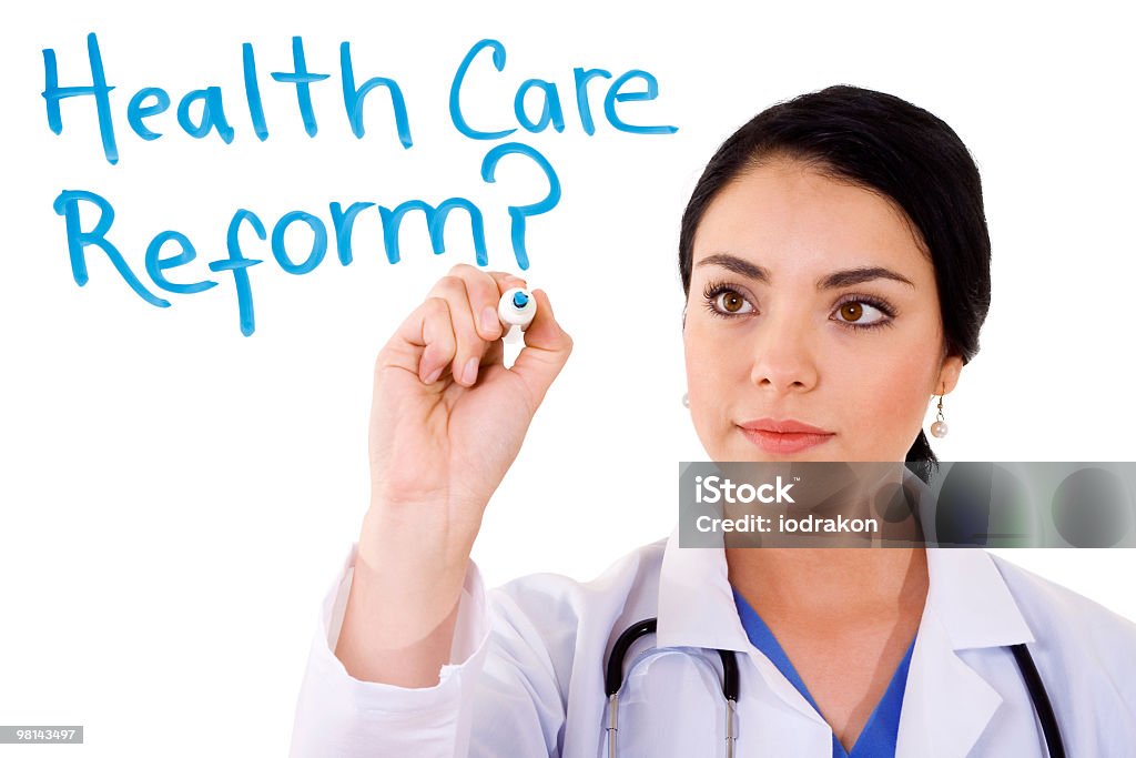 A woman writing health care reform on a board Stock image of female doctor writing on whiteboard: Health Care Reform?... over white background Adult Stock Photo