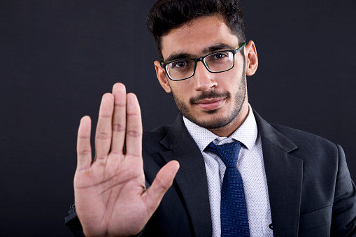Portrait of businessman showing hand stop sign