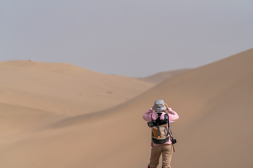 female backpacker exploring on gobi desert