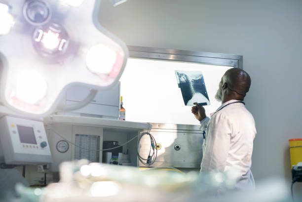 Doctor looking at x-ray on lightbox in hospital