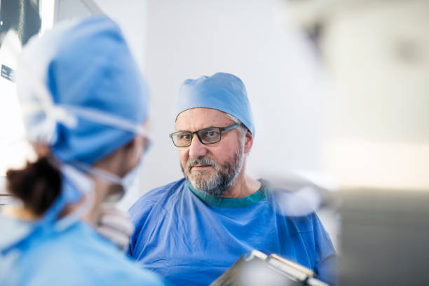 istock Surgeon looking at colleague in examination room 981472732