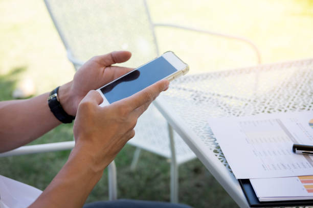 istock Cropped Image Of Man Using Mobile Phone 981478584