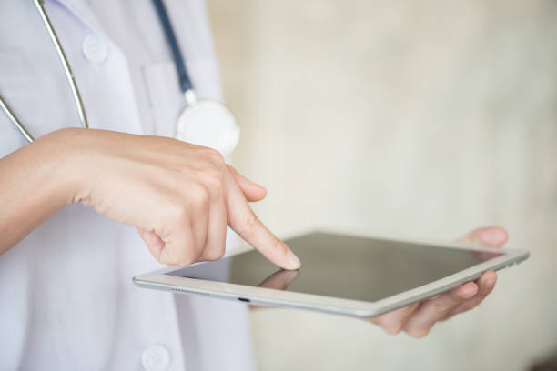 istock Midsection Of Doctor Using Digital Tablet At Hospital 981483758