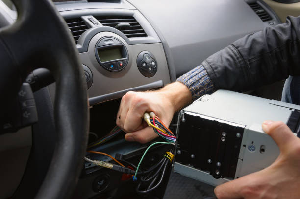 Male hands remove audio system from car dashboard Automobile receiver disconnecting and removing car audio equipment stock pictures, royalty-free photos & images