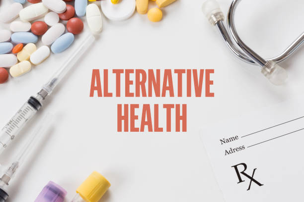 istock ALTERNATIVE HEALTH written on white background with medication 981489830