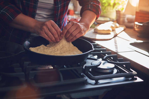 istock Preparing Homemade Pizza in Domestic Kitchen 981496442