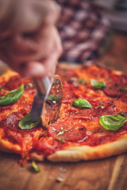 istock Homemade Pizza with Salami and Basil 981499362
