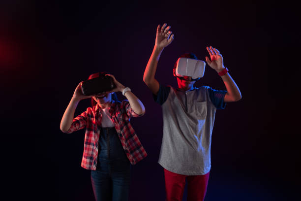 istock Joyful kids wearing VR headsets 981500532