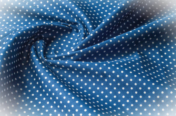 istock Texture background pattern. Silk fabric, blue cloth in white peas. On a black background. Flower textile or fabric. Texture of fabric. Fabric, textiles, fabric, material, woven. 981506050