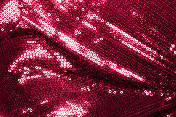 istock Background texture, pattern. Cloth red maroon with paillettes. Look at these Neon Pink Paillette Sequins. Round neon pink paillette sequins overlap with an iridescent sheen across a sheer purple mesh 981506530