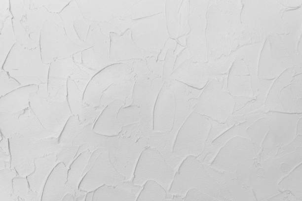 istock White rough grunge concrete wall. Abstract texture cement material. 981516924