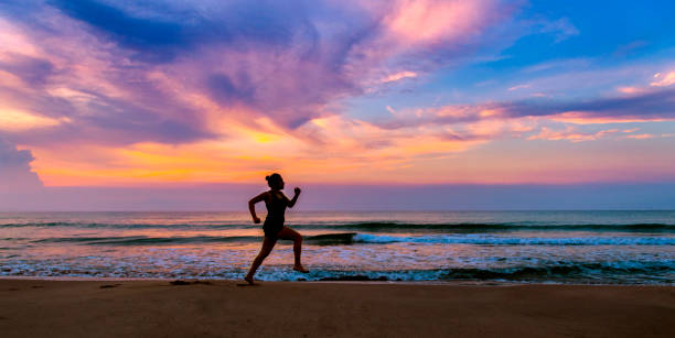 istock Woman running at beach 981517004