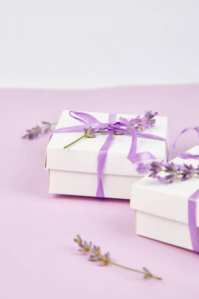 istock White Gift box with violet ribbon and lavender 981517212