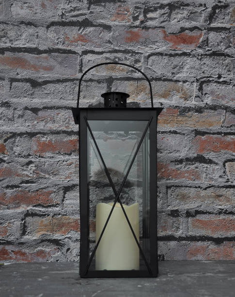 istock Lantern n in front of brick wall 981517250