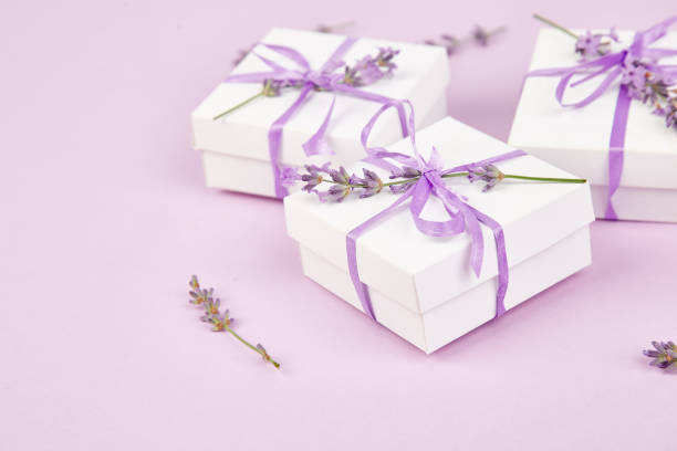 istock White Gift box with violet ribbon and lavender 981517252