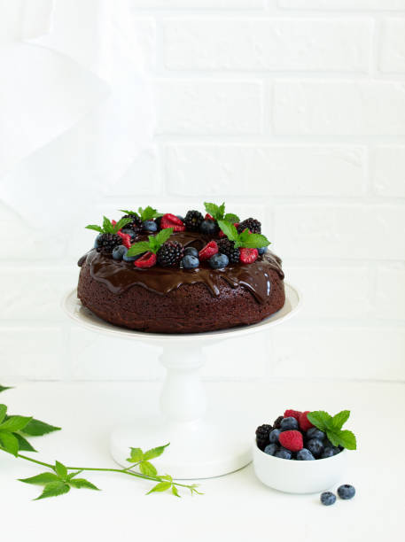 istock Chocolate cake with glaze and fresh berries 981521308