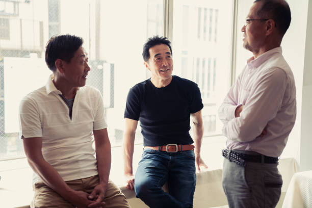 istock Three senior male friends talking happily at the window 981523152
