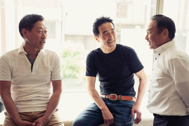 istock Three senior male friends talking happily at the window 981523256