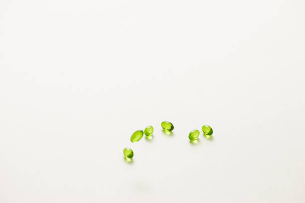 Top view many gel capsules on white background isolated. Vitamin E 200 mg capsules.