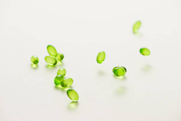istock Top view many gel capsules on white background isolated. Vitamin E 200 mg capsules. 981527680
