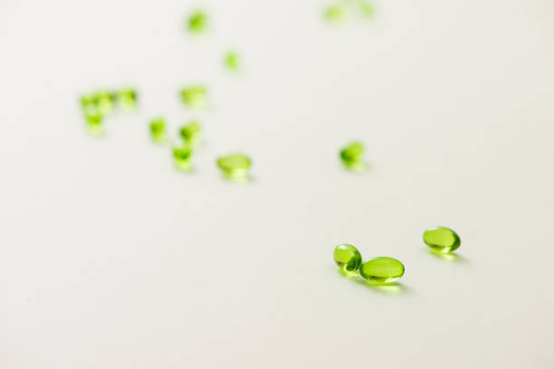 istock Top view many gel capsules on white background isolated. Vitamin E 200 mg capsules. 981527720
