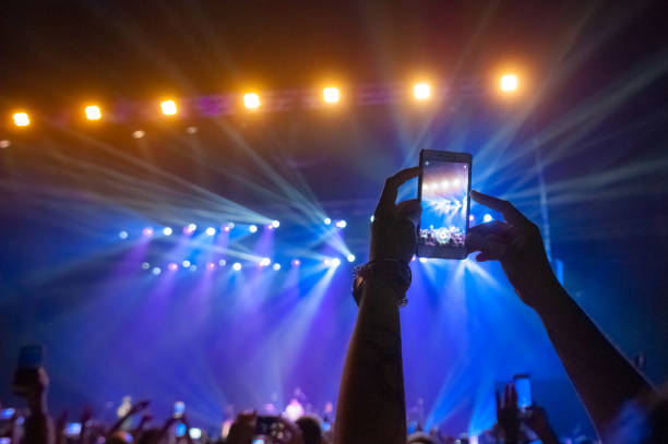 istock People in the crowd at a concert make video recordings and pics 981528068