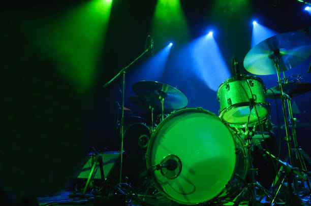 istock A kit of drums and a microphones on an empty stage 981528090