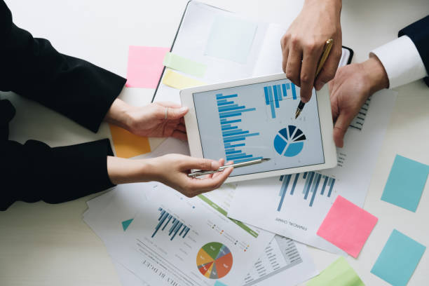 istock Business team hands at working with financial plan, meeting, discussion, brainstrom with tablet on office desk, Top view shot. 981533120