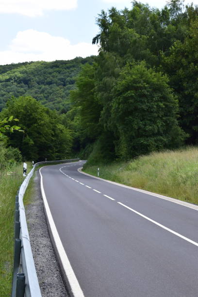 istock bend of a empty country road 981533216