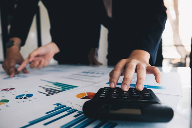 istock Close up Businessman and partner using calculator for calculating financial document, tax, accounting, statistics and analytic research concept 981533714