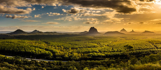 Panoramic view of Glass House Mountains at sunset visible from W Panoramic view of Glass House Mountains at sunset visible from Wild Horse Mountain Lookout, Australia queensland stock pictures, royalty-free photos & images