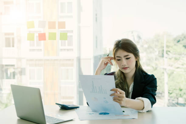istock Asian young woman working with laptop and think project for financial document at modern office, business and financial concept. 981537832