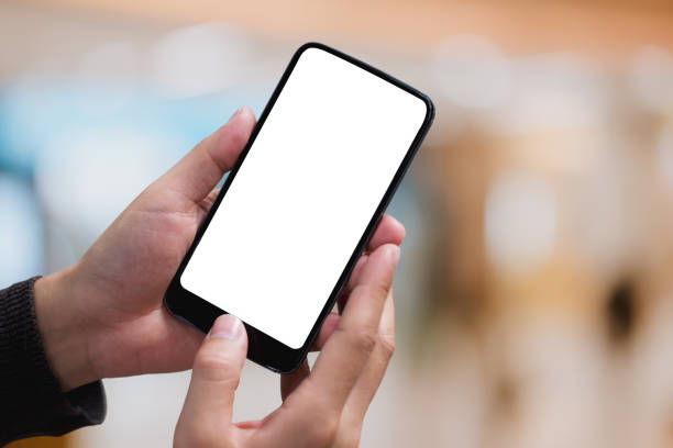 istock Man hand holding smartphone. Blank screen mobile phone for graphic display montage 981538312