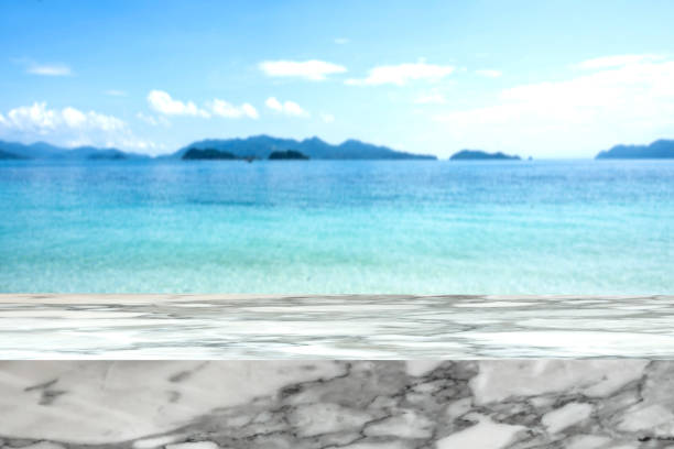 istock Marble stone mock up template over blurred tropical blue sea 981542696