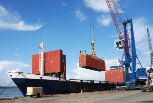 Loading Container Ship Port Panama City - commercial loading dock at Port Panama City Florida. An empty container ship receives new containers from crane