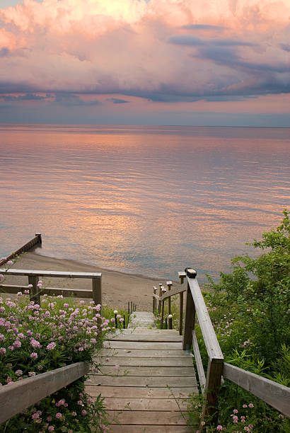Steps to Paradise Wooden steps down to the beach at sunset. lake erie stock pictures, royalty-free photos & images