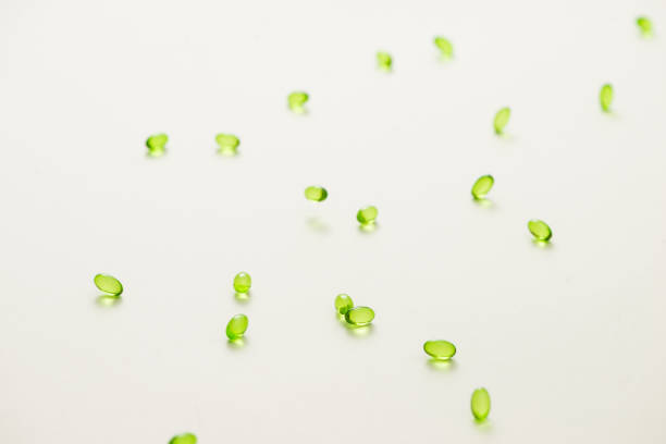istock Top view many gel capsules on white background isolated. Vitamin E 200 mg capsules. 981554564