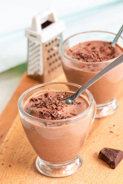 istock Healthy dessert chocolate pudding serving cups wooden cutting boarding. Selective focus. 981576706