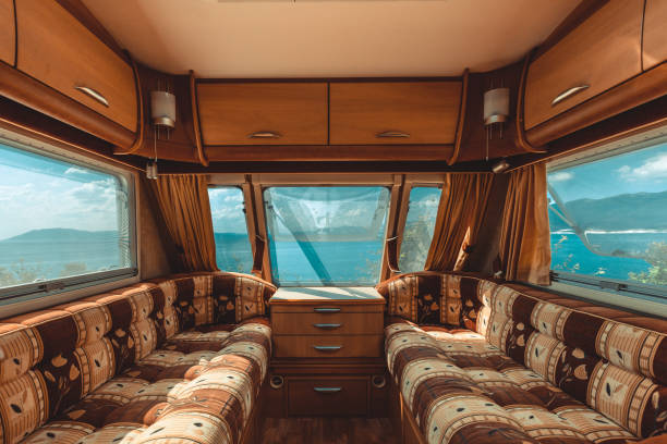 Caravan trailer with sea view, view from the inside, point of view shot. Road adventure stock photo