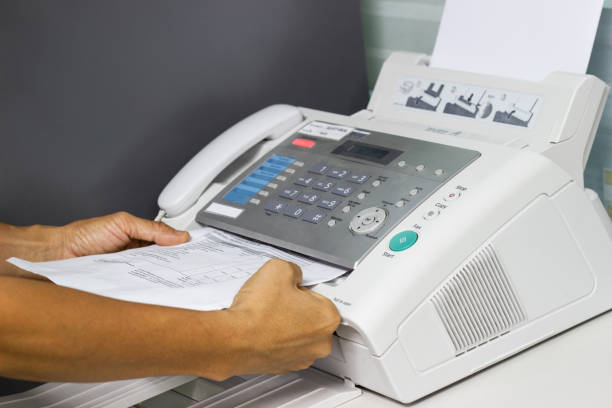 istock hand man are using a fax machine in the office 981581508