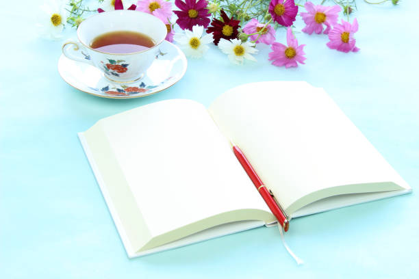 istock cosmos  (flower) and book and tea 981586702